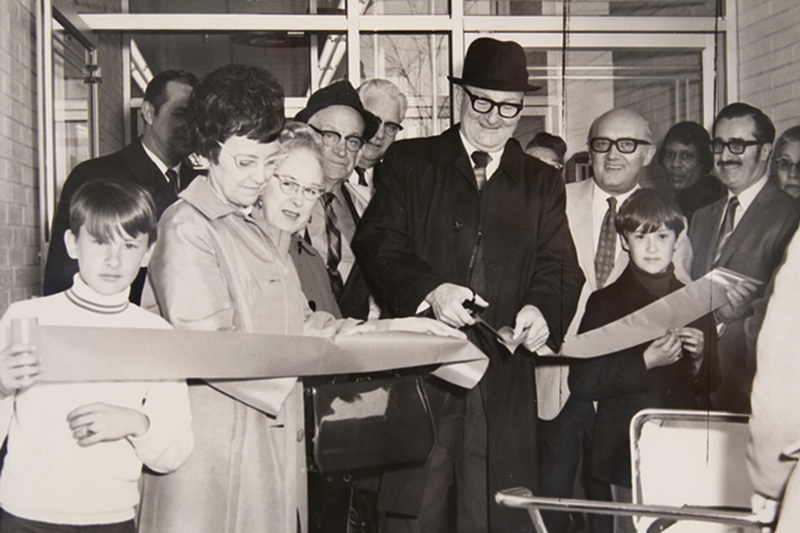 Marvin Weiss cutting an opening ribbon at a new grocery store in the 1960's